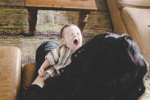 Baby yawning on moms lap